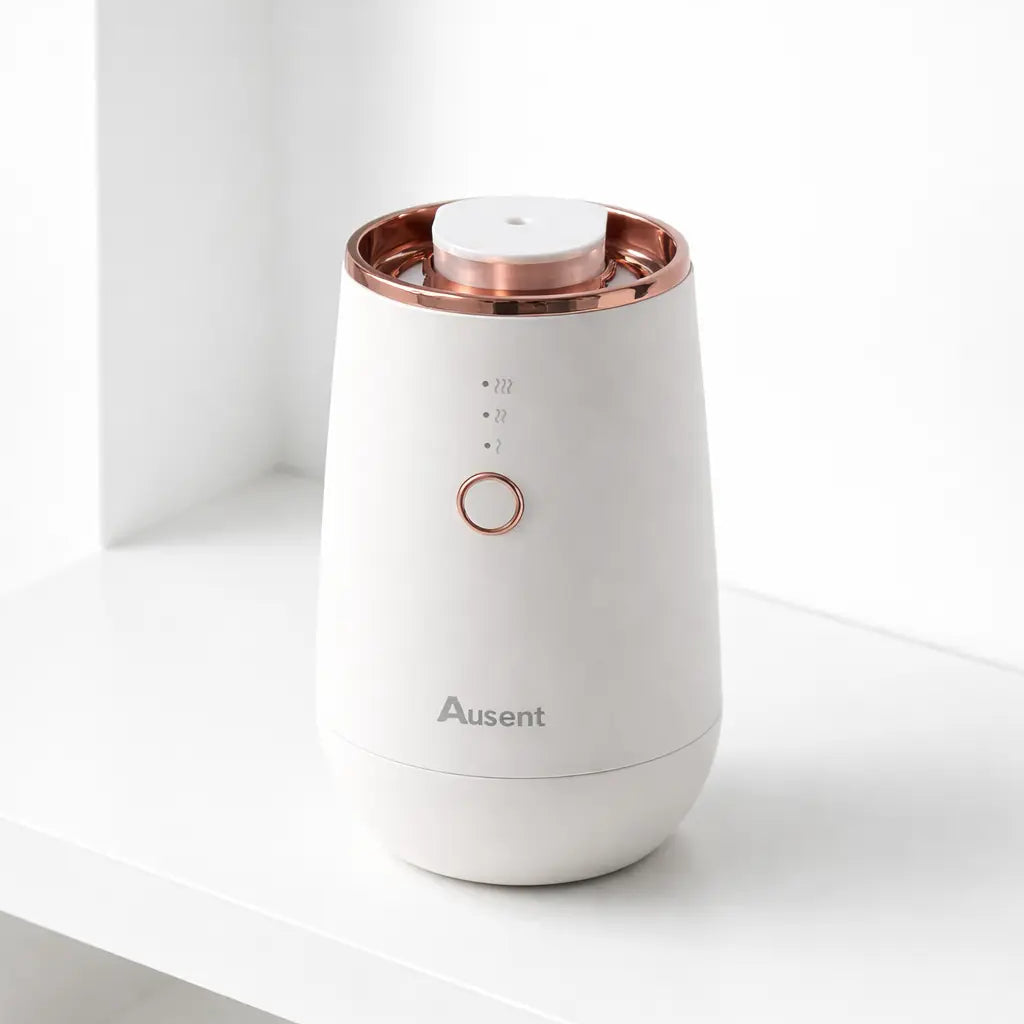 Ausent Aura One waterless aromatherapy diffuser in white with rose gold top, front view